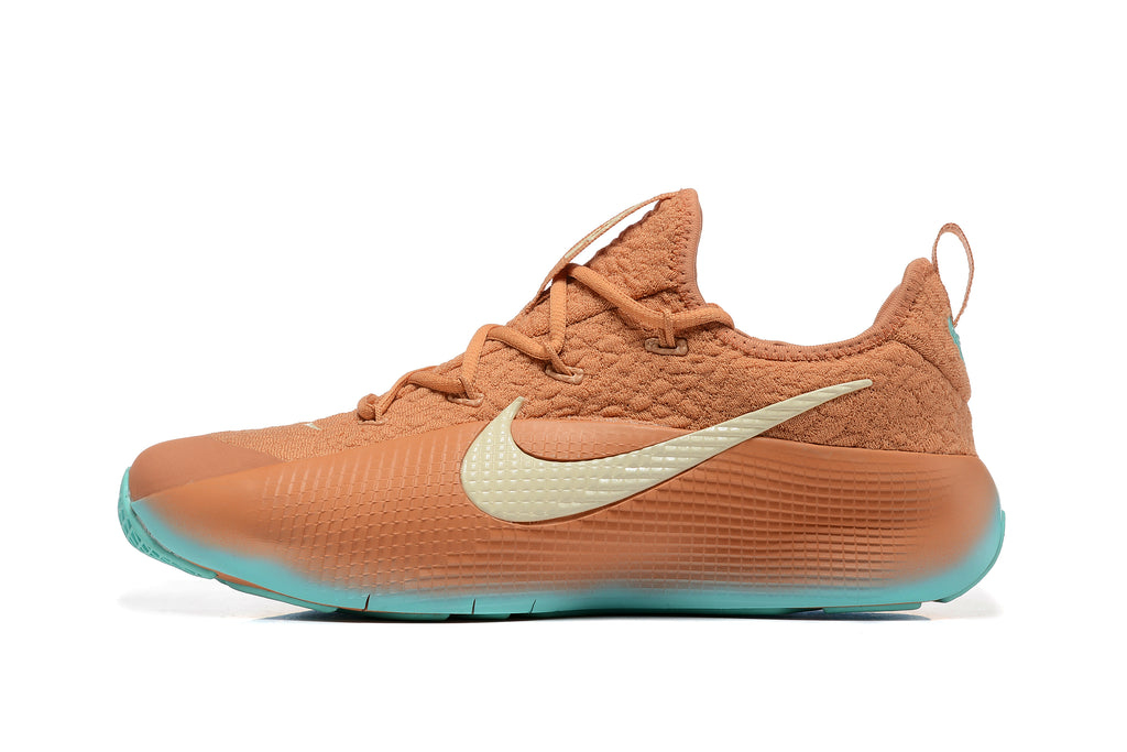 Side profile of a warm orange Nike LeBron TR1 shoe with a light-colored Swoosh