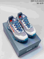 Pair of KAILAS FUGA EX330 trail shoes in blue, gray, white, and orange displayed on an EX330 shoebox; visible text includes style code 2607JLD116A16 and size range 36–45.5.