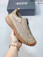 Side view of a beige ECCO shoe showing mesh-look panels, front zipper, and treaded outsole.