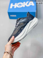 Side profile showing the dark mesh upper, lace system and raised white midsole.