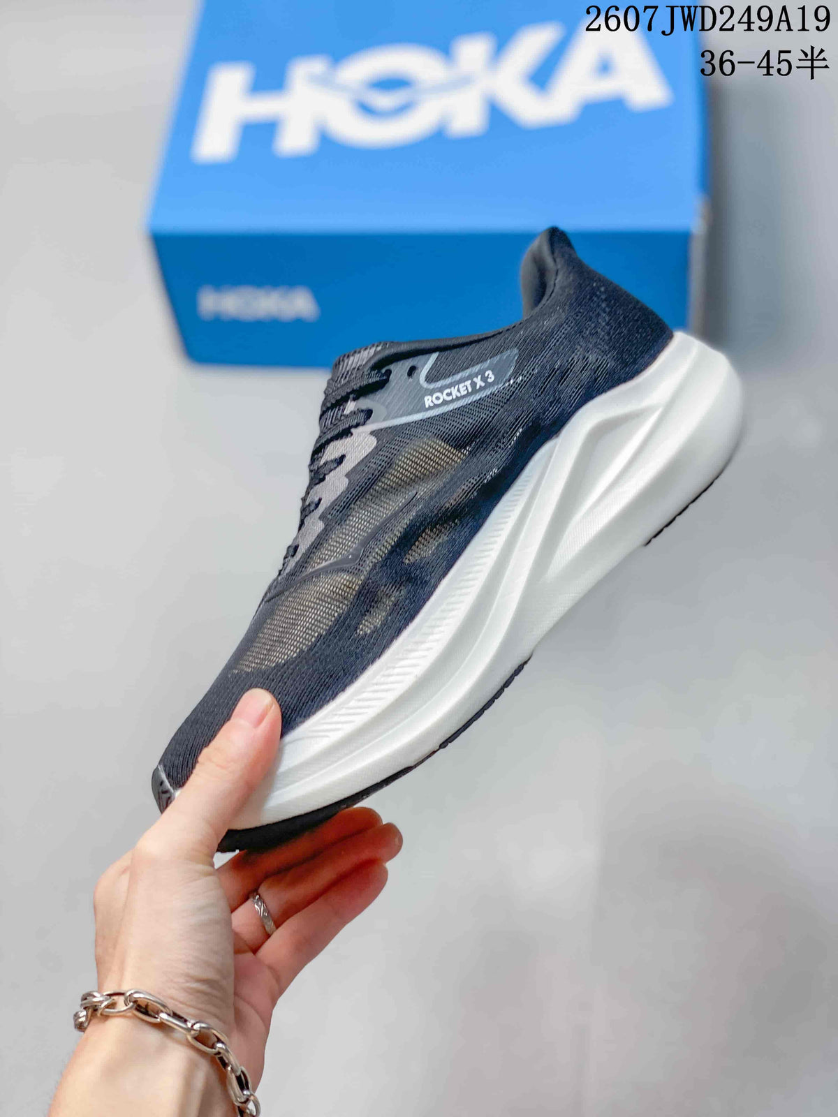 Side profile showing the dark mesh upper, lace system and raised white midsole.