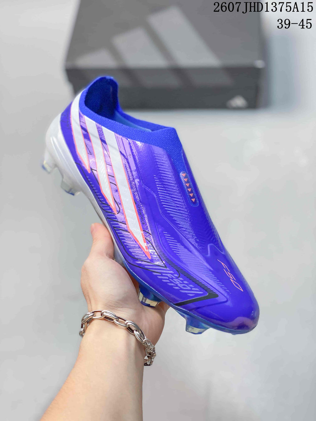 Side view of a purple adidas F50 Elite football boot showing the streamlined upper, side stripes and molded studs.