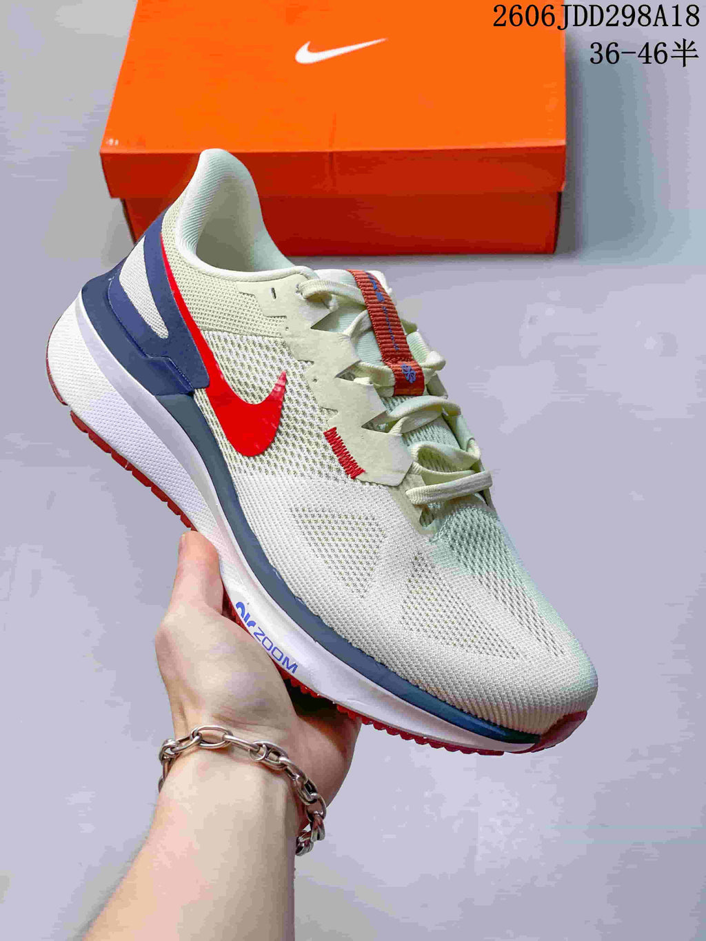 Angled side view of the white Nike running sneaker with red Swoosh, blue heel overlay, and visible Air Zoom marking.