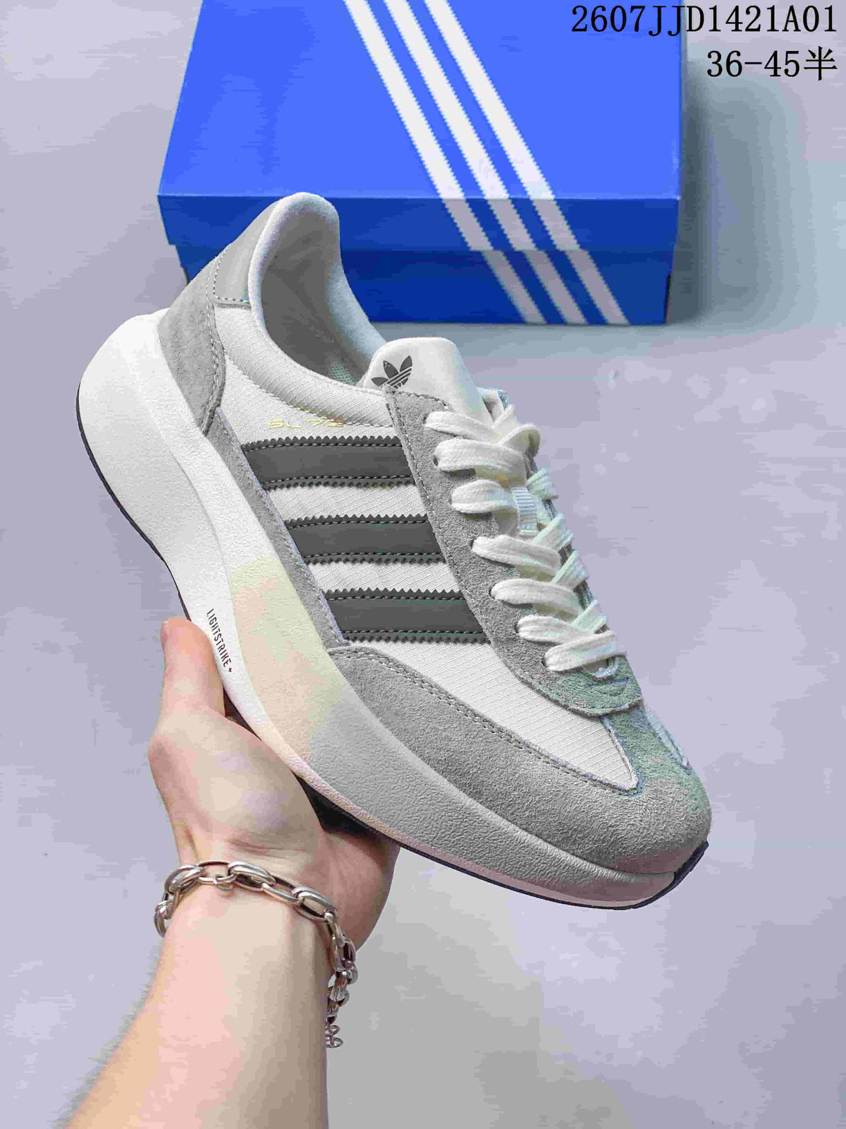 Angled side view showing the layered upper and three-stripe detailing