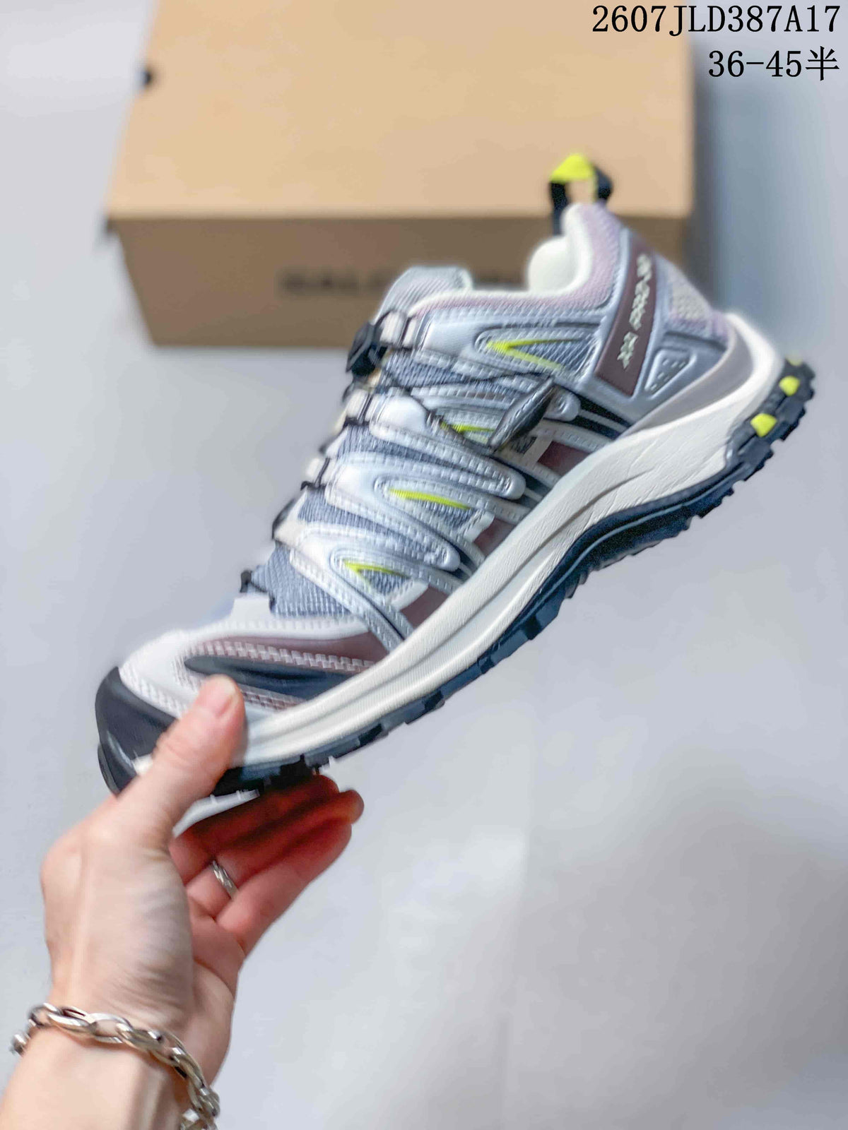 Side view of a Salomon XA PRO 3D shoe showing the grey upper, purple accents, lime details and black lugged outsole.