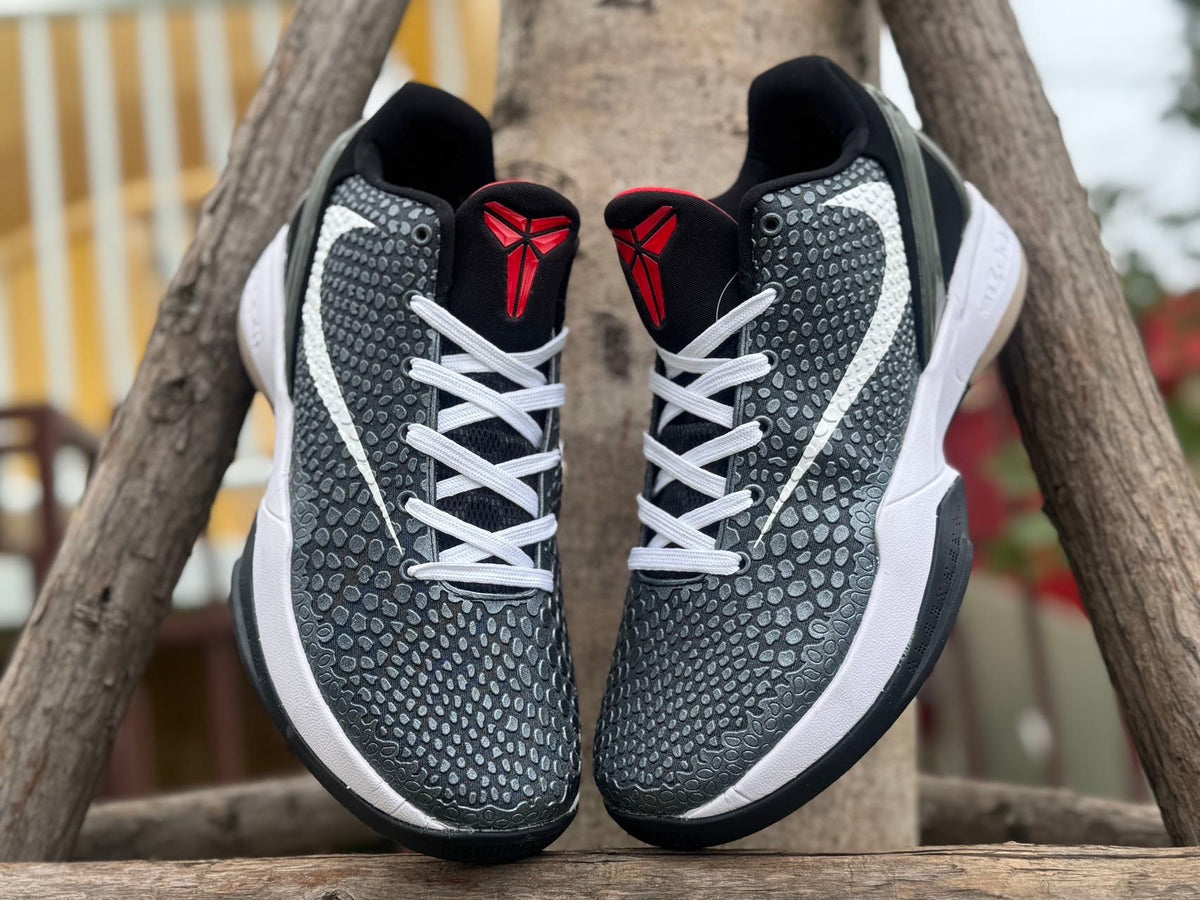 Front view showing white laces and red Kobe logos on the tongues