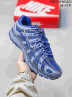 Angled side view showing the blue and gray upper, lace system, and low-top silhouette