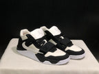 Front three-quarter view of the pair highlighting the black toe overlays, white panels, and strap closures.