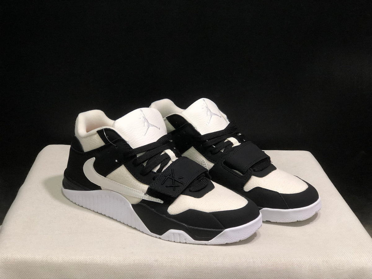 Front three-quarter view of the pair highlighting the black toe overlays, white panels, and strap closures.