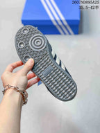 Outsole view of the sneaker showing the textured gray rubber tread and adidas branding.