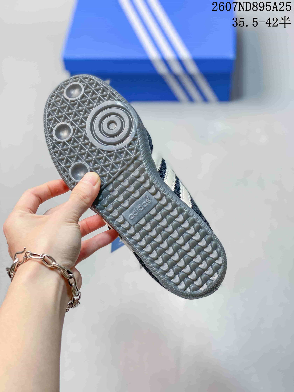 Outsole view of the sneaker showing the textured gray rubber tread and adidas branding.