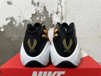 Rear view of Nike Air Flightposite shoes showing black heels, gold embroidery, and white soles