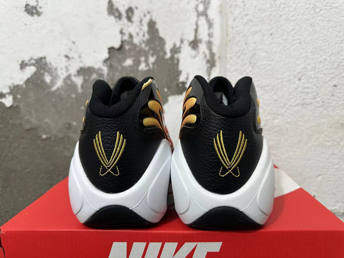 Rear view of Nike Air Flightposite shoes showing black heels, gold embroidery, and white soles