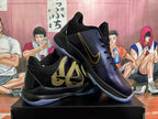 Pair of black and purple Nike basketball shoes with gold accents and translucent blue outsoles