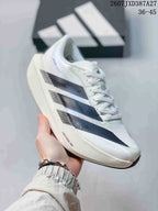Angled side view of the white adidas sneaker with black patterned stripes and visible Lightstrike Pro branding.