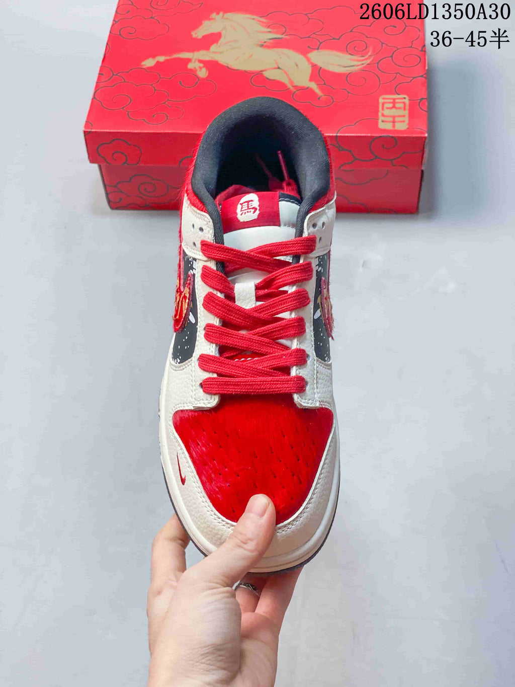 Top view of a red and cream Nike SB Dunk Low with red laces