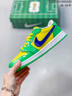 Side view showing the yellow upper panel, blue Swoosh, green overlays and white midsole.
