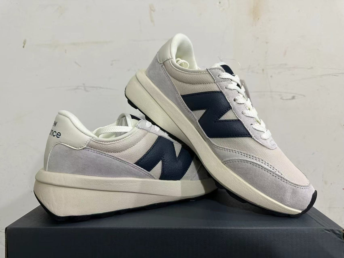 New Balance U370 sneakers displayed together, showing the side logo and layered upper.