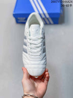 Top view showing the white laces, adidas tongue logo, and quilted toe detailing.
