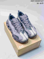 Pair of gray, black and white On sneakers displayed on a shoebox, with the style code and size range shown above.