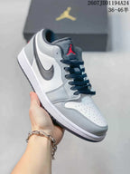 White and grey low-top Jordan sneaker shown from a front three-quarter angle, with a red tongue logo and dark laces.