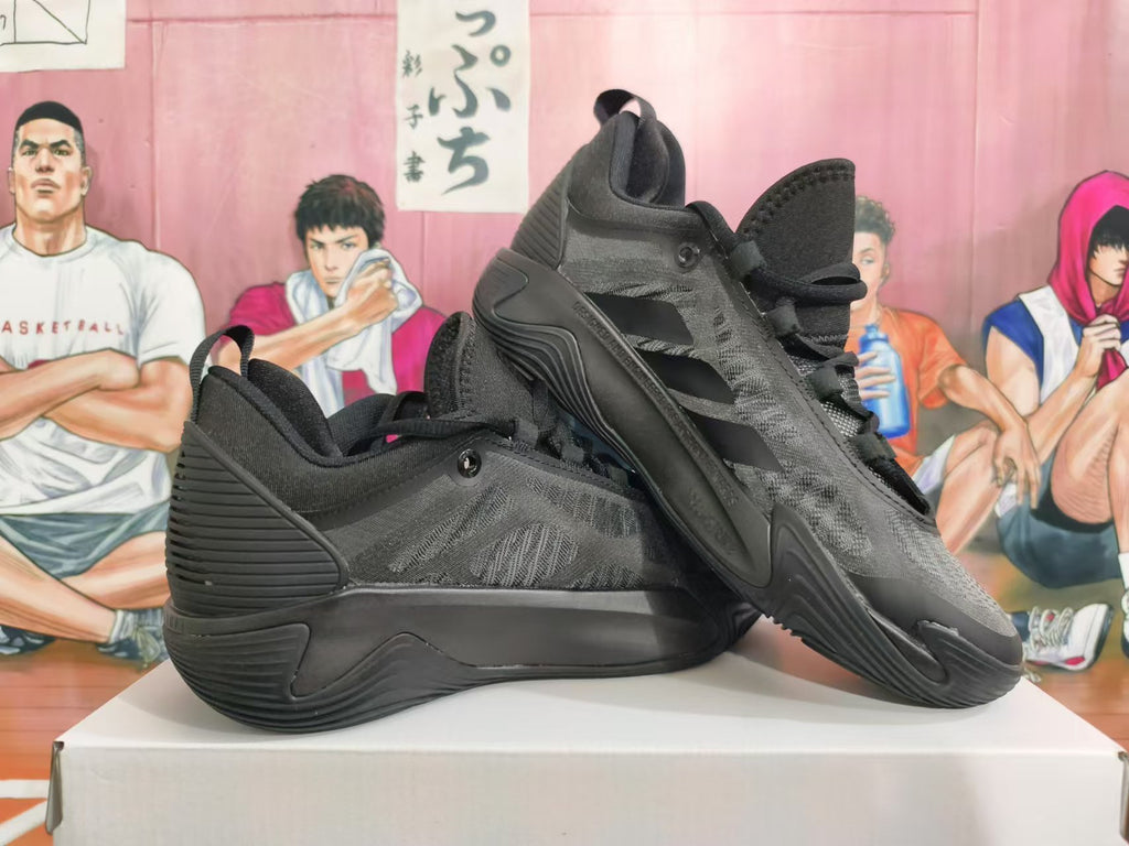 Pair of all-black Nike basketball shoes arranged in an overlapping side view
