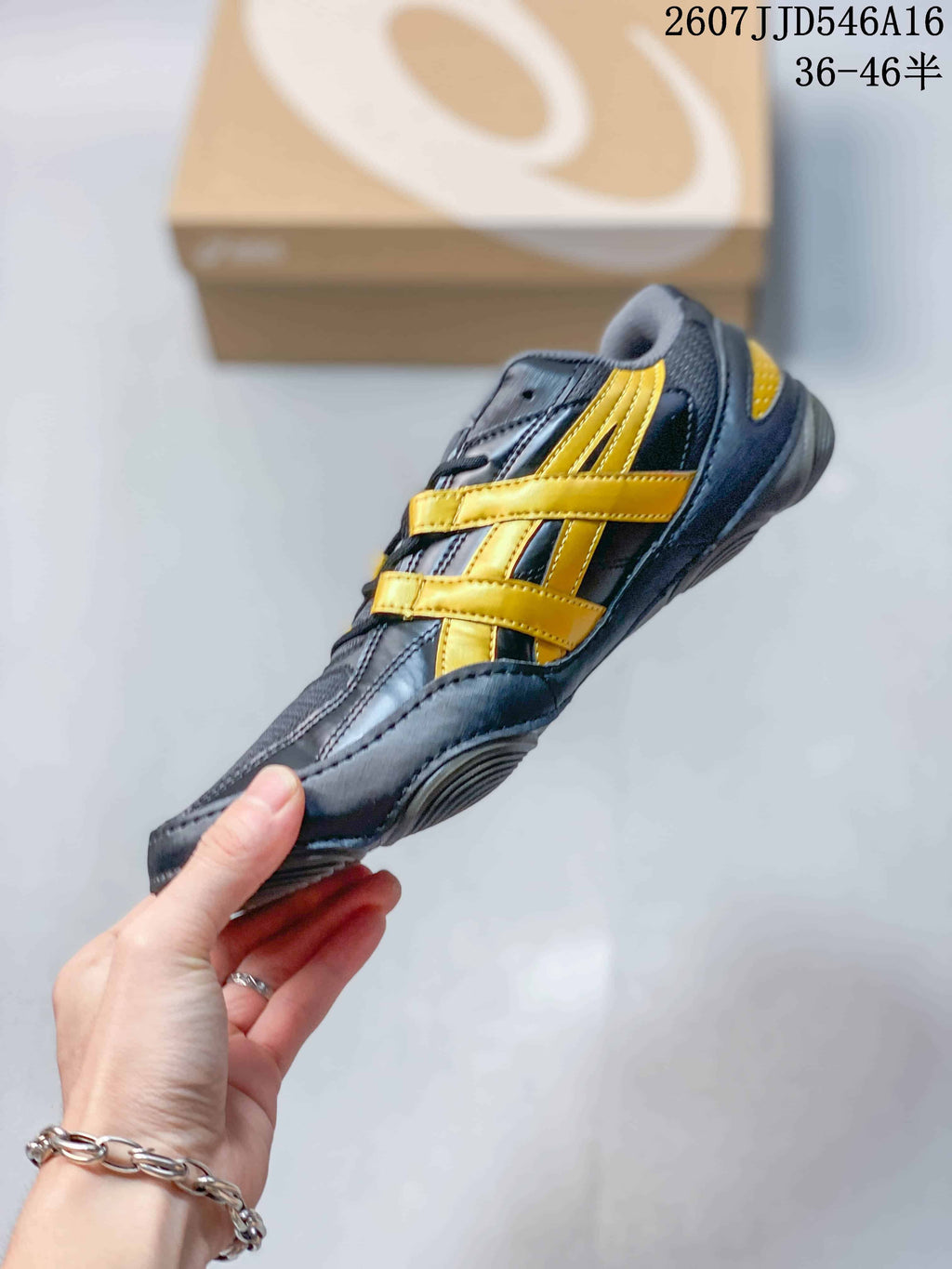 Side profile of the navy and yellow ASICS sneaker highlighting the layered side detailing and low-profile sole.
