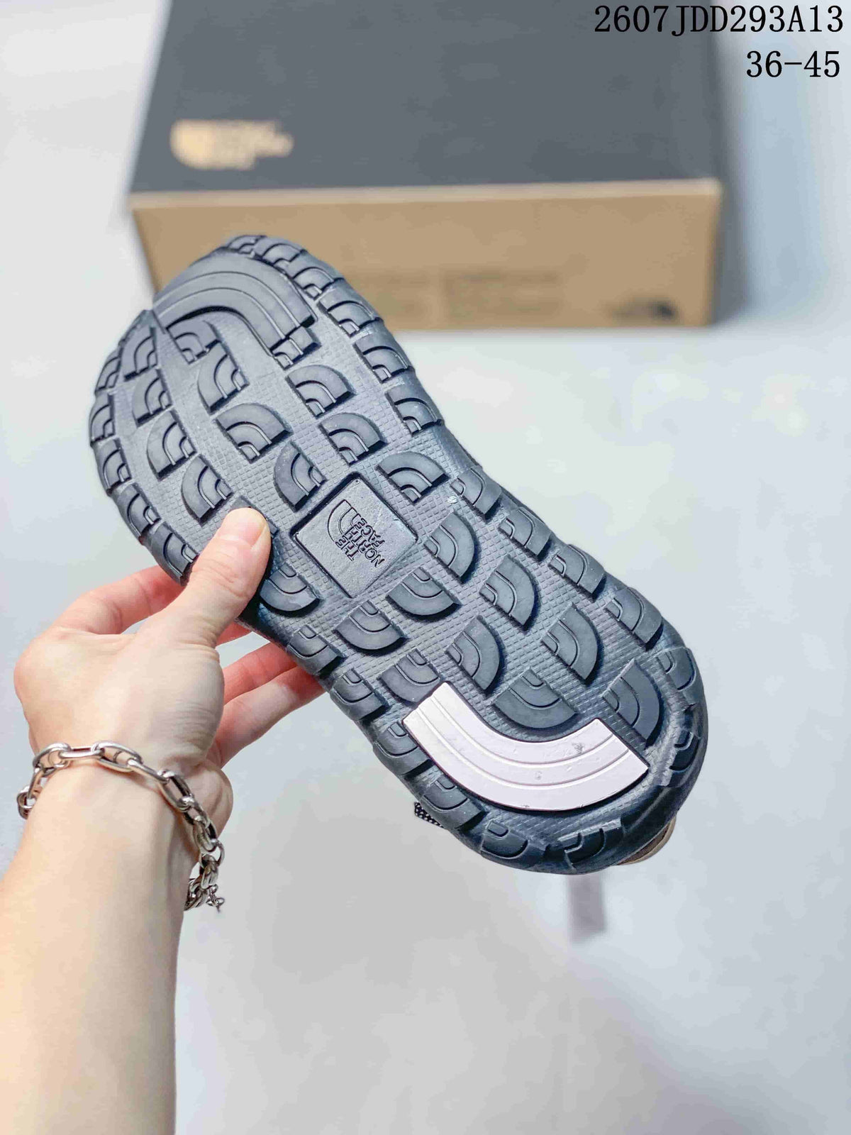 Close-up of the black sandal outsole showing its deep, patterned tread.