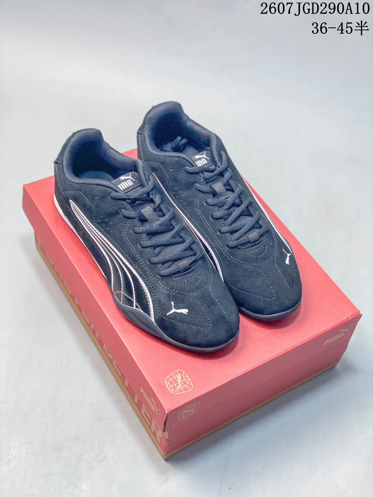 Pair of black Puma low-top sneakers with white side branding displayed on a red Puma shoebox.