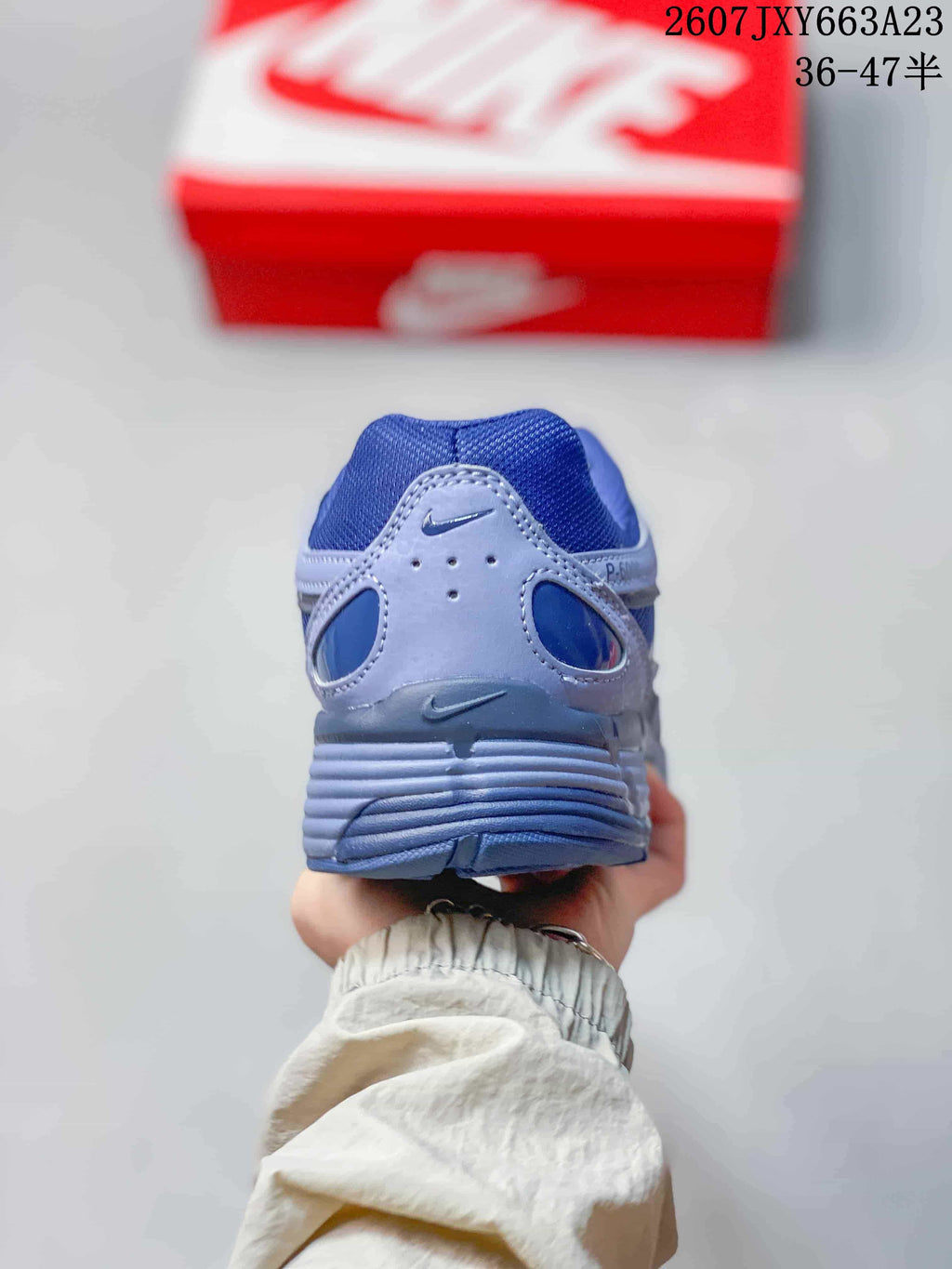 Rear view showing the padded heel and layered blue and gray construction