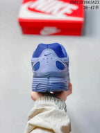Rear view showing the padded heel and layered blue and gray construction