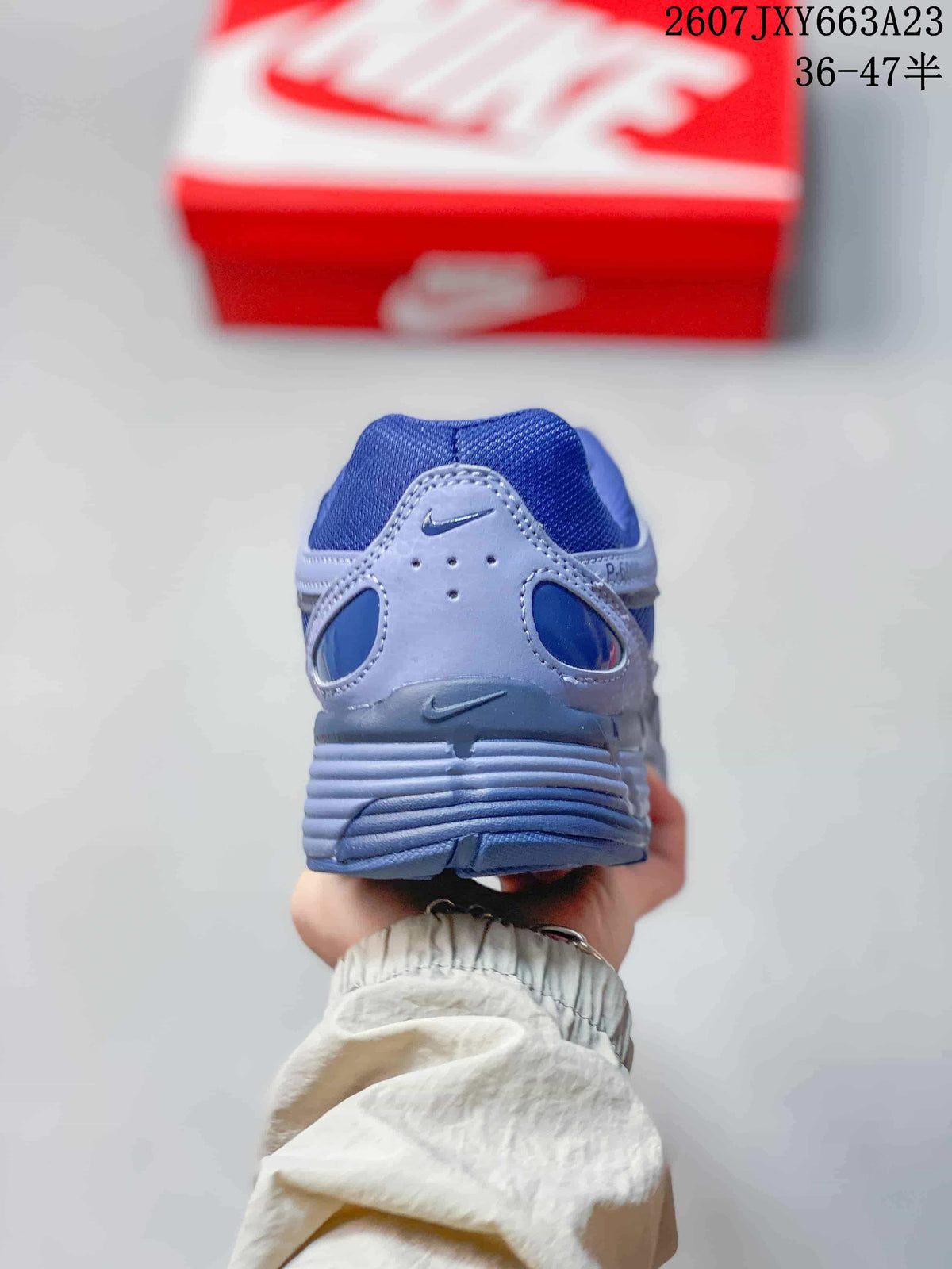 Rear view showing the padded heel and layered blue and gray construction