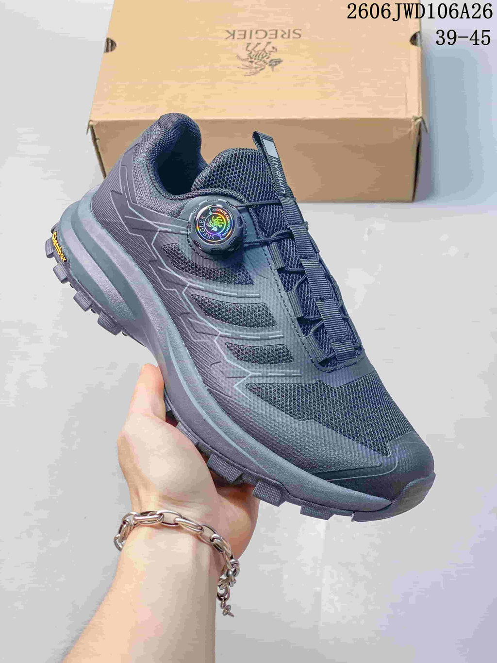 Side view of a dark navy SREGIEK sneaker showing mesh-look panels, dial-style closure, and treaded sole.