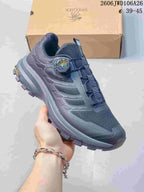 Side view of a dark navy SREGIEK sneaker showing mesh-look panels, dial-style closure, and treaded sole.