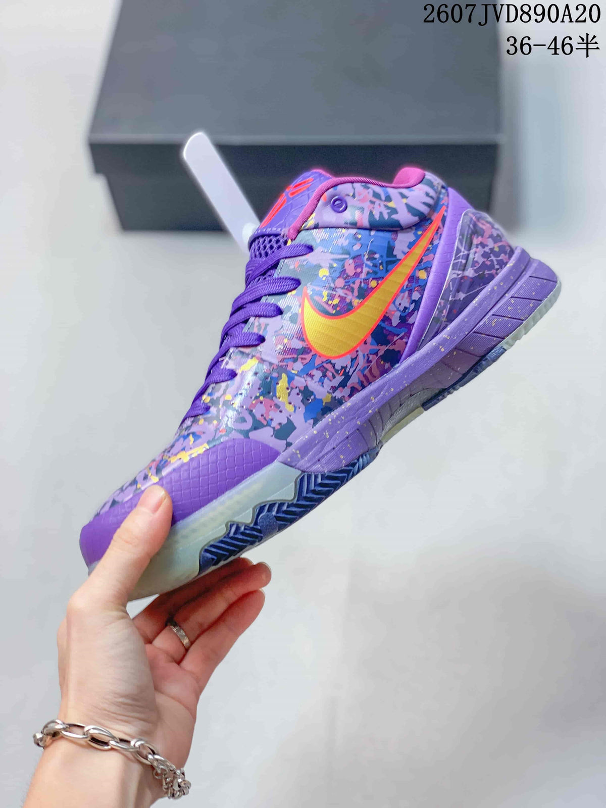 Side view of the purple low-top basketball shoe showing the multicolor upper, yellow-orange Swoosh and layered sole.