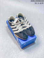 Pair of navy and cream Tokyo MJ low-top sneakers with gum-colored soles.