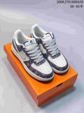 Pair of ivory and dark navy patterned low-top sneakers on an orange box