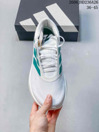 Top view of a white ZenBoost lace-up shoe with a textured toe and green side accents.