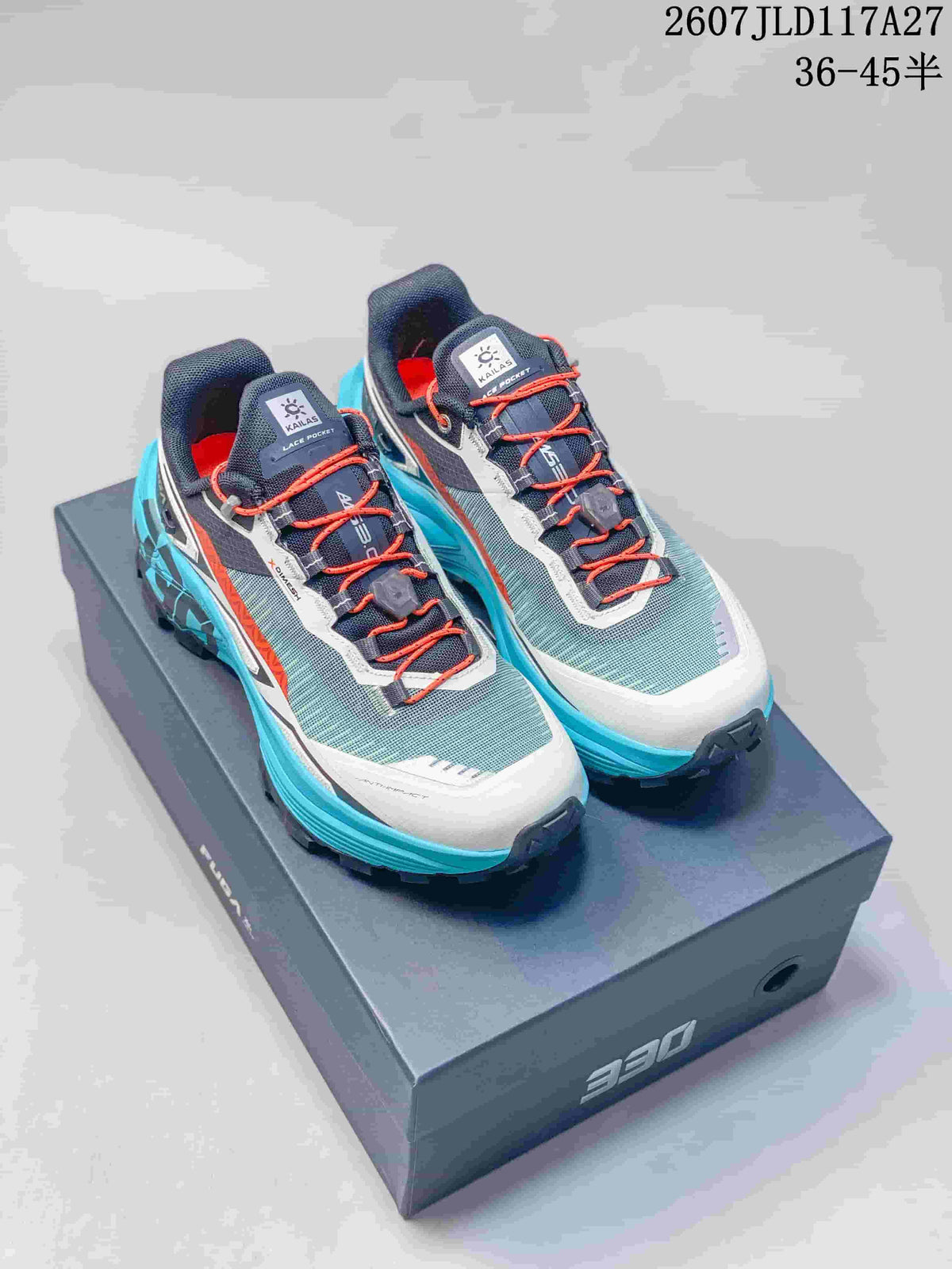 Pair of KAILAS FUGA EX330 trail running shoes in teal, black, white, and orange, shown on a shoebox.