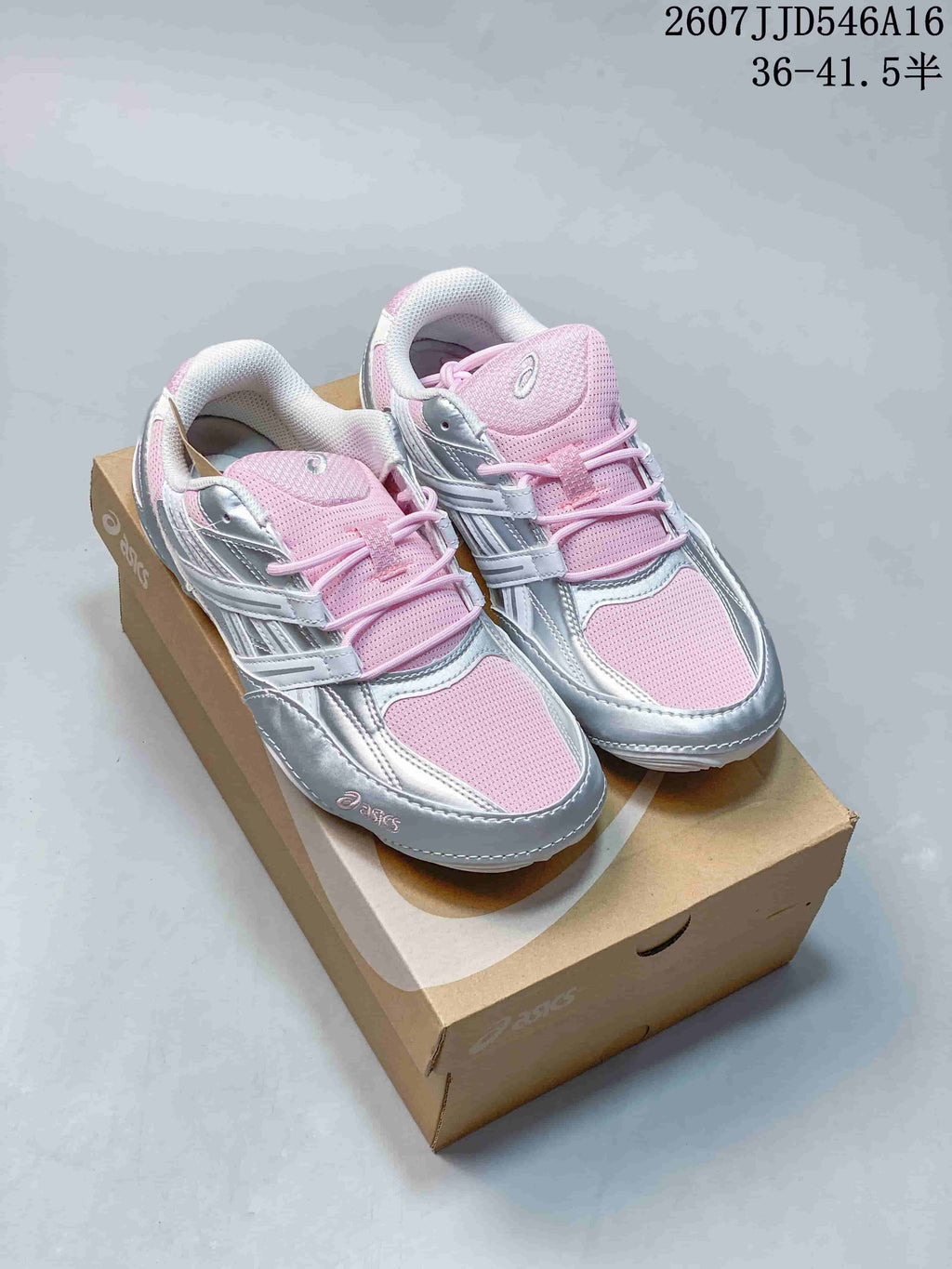 Pink and silver ASICS Hypersync sneakers displayed on an ASICS shoebox.