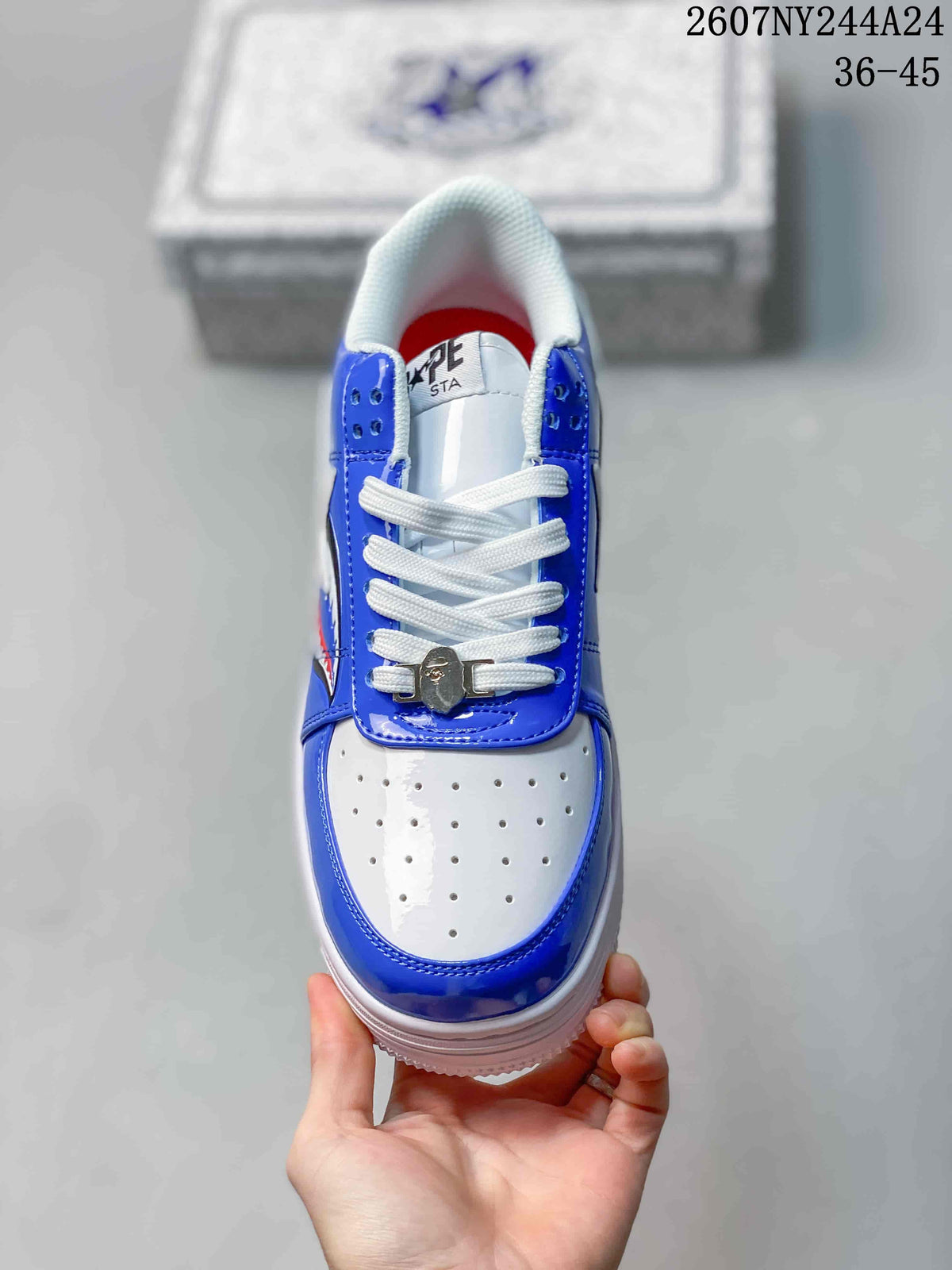 Top view showing white perforated toe box, blue overlays, white laces, and metal lace accessory.
