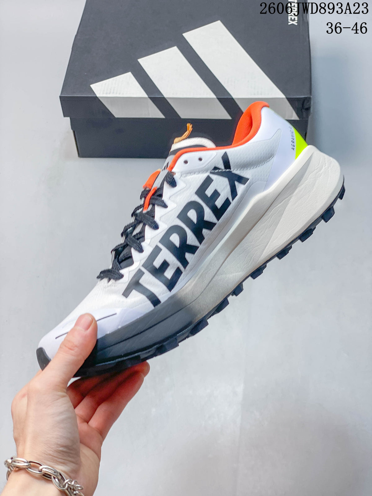 Side view of a white Terrex Agravic 4 shoe with dark gray graphics and a lugged outsole.