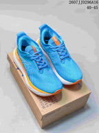 Pair of blue ASICS GEL-Nimbus 25 running shoes with orange and white accents displayed on a shoebox; image text shows style code 2607JJD296A16 and size range 40–45.