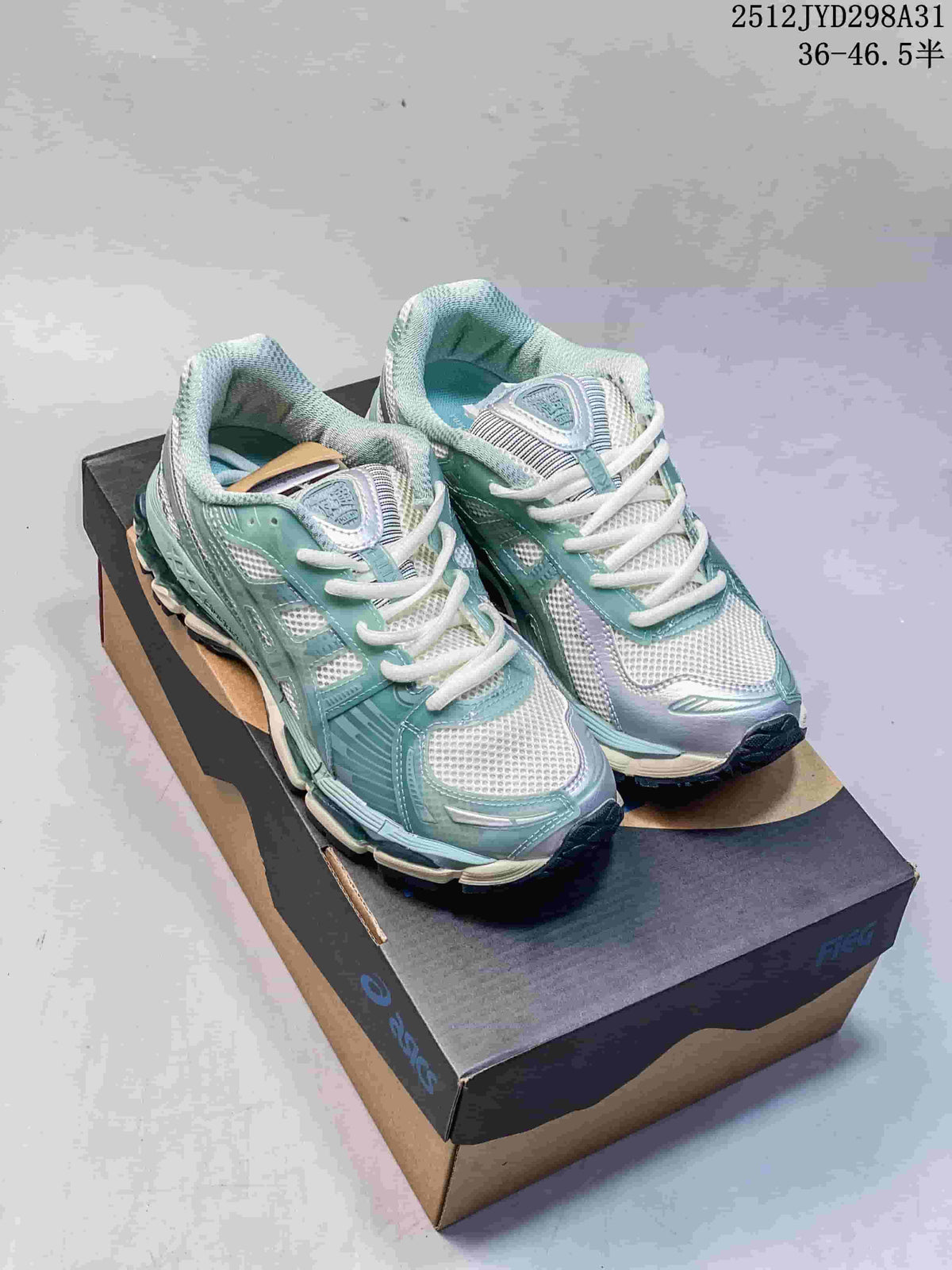 Pair of pale green and white ASICS Gel-Kayano 12.1 shoes shown on a shoebox