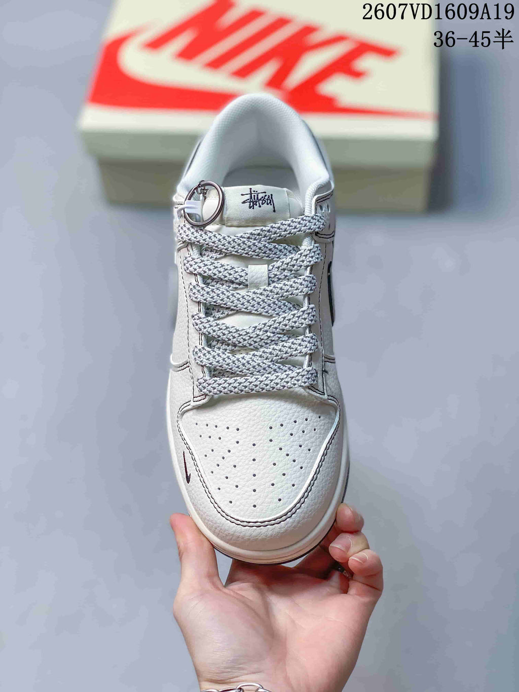 Top view showing the perforated white toe box, patterned laces, padded collar and tongue branding.