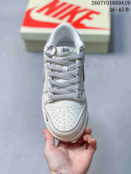 Top view showing the perforated white toe box, patterned laces, padded collar and tongue branding.