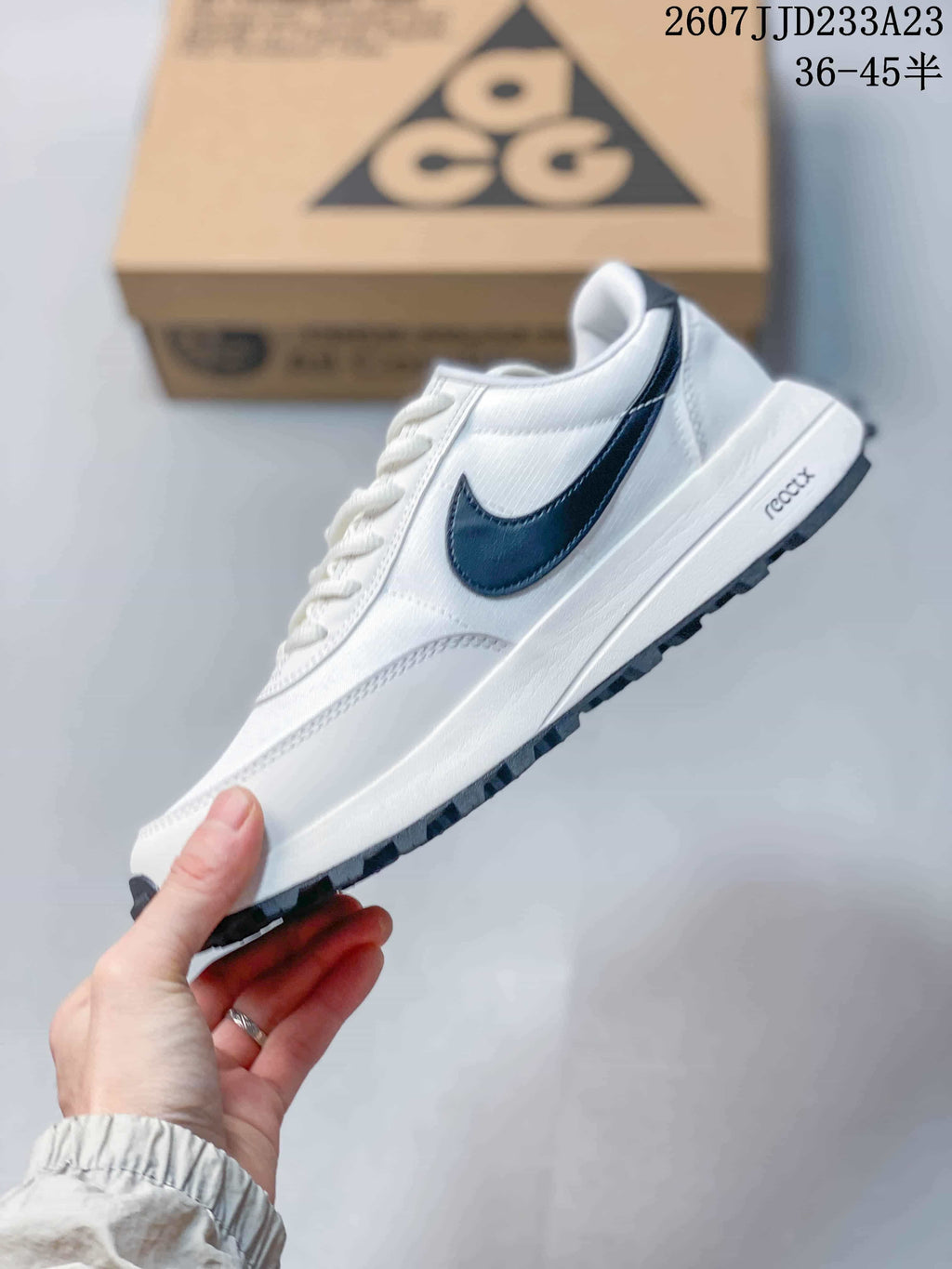 Side profile highlighting the white upper, navy Swoosh, layered panels, and lugged outsole.
