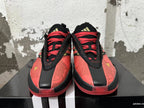 Front view of red and black basketball shoes with floral pattern and red laces