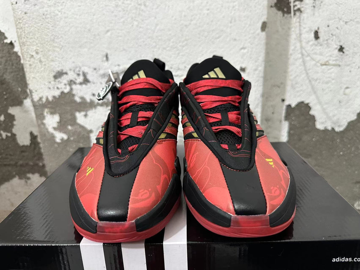 Front view of red and black basketball shoes with floral pattern and red laces