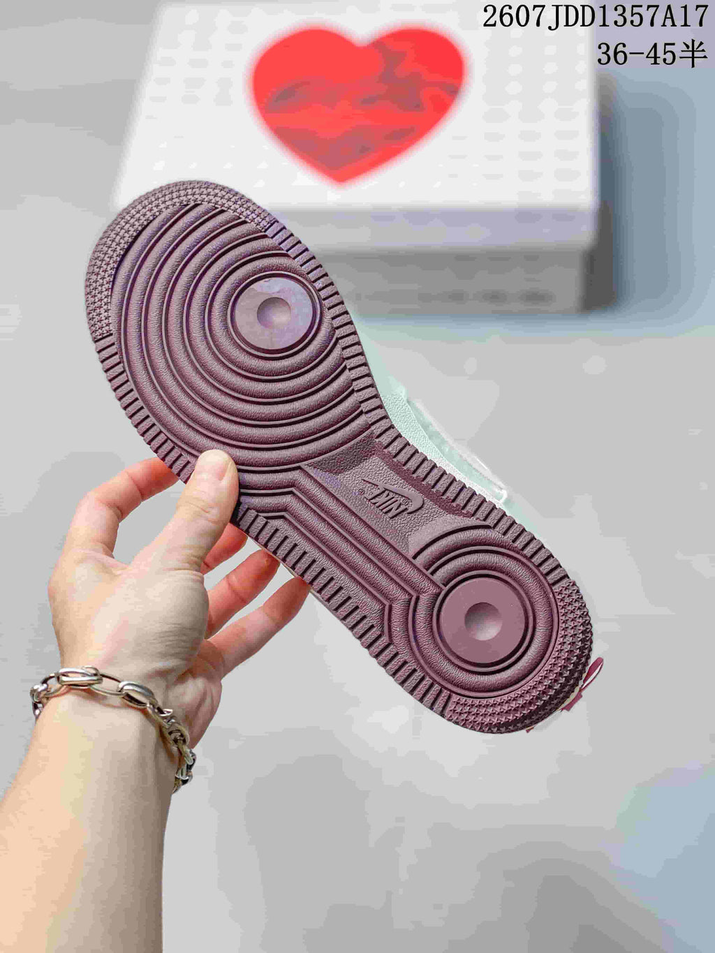 Close view of the mauve outsole showing circular traction patterns and AF1 branding.